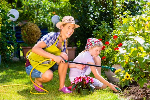 Professional gardener trimming hedges in Earls Court